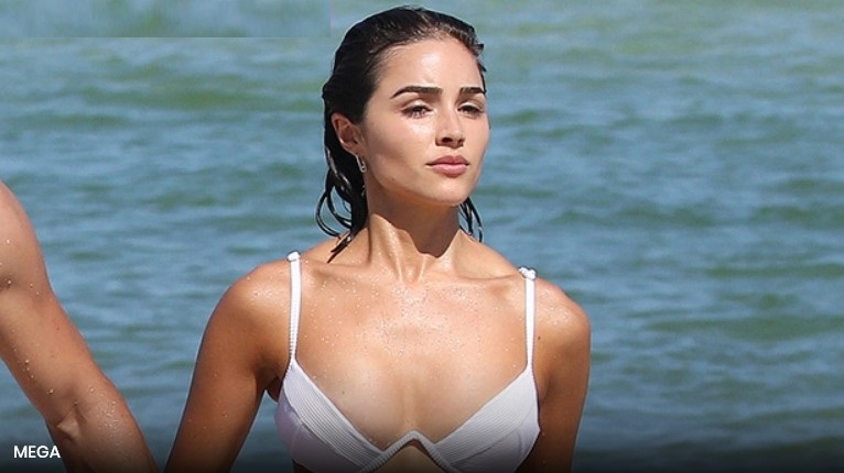 Olivia Culpo Rocks White Crop Top WithNothing Underneath In BTS Look At ‘SISwimsuit’ Shoot